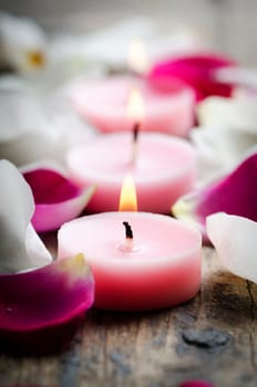 Spa candles and rose petals.