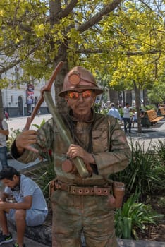 a mime disguised as a miner on a street in Santiago, Chile