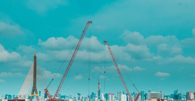Panorama scenic of Construction Skyline with Blue sky Background and crane on construction Site. Cityscape Urban Facility