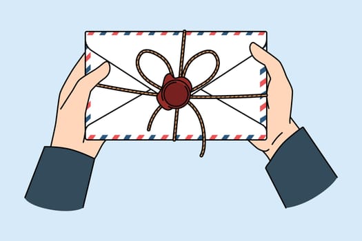 Post service and letter concept. Postman hands holding letter for person with official post stamp in envelope vector illustration