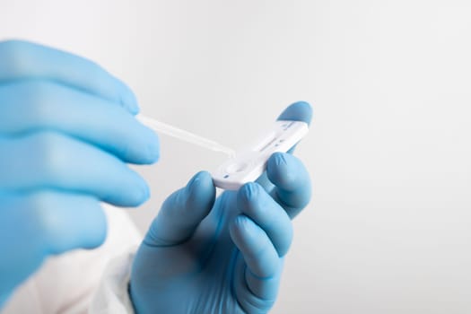 Medical healthcare holding COVID-19, coronavirus swab collection kit, wearing protective suit