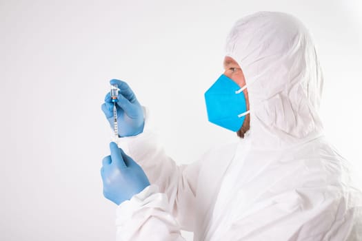 COVID-19 coronavirus vaccine. Vaccination concept. Doctor's hand in blue gloves hold medicine vaccine vial bottle and syringe.