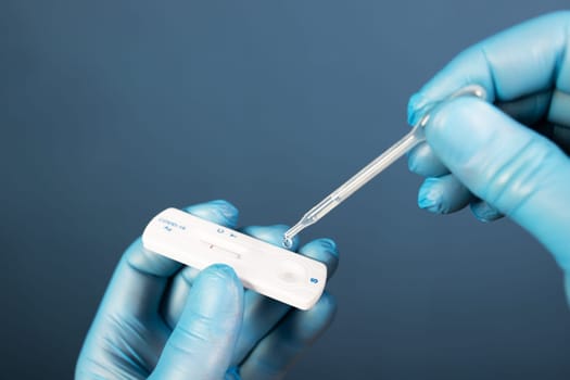 Medical healthcare holding COVID-19, coronavirus swab collection kit, wearing protective gloves