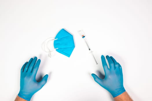 Flat lay of vaccine, test and medical mask. The concept of prevention during Coronavirus pandemic.