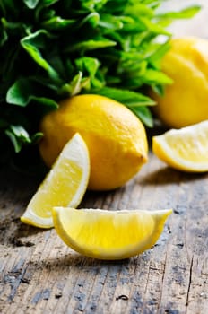 Lemon slices and spearmint on rustic wooden table