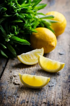 Lemon slices and spearmint on rustic wooden table