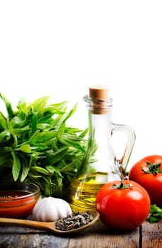 Olive oil, tomato and herbs over white background
