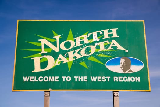 Bullet holes riddle the welcome sign for North Dakota