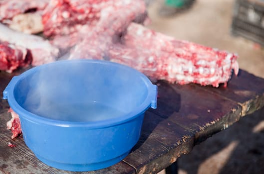Hot water bucket for cleaning process. Traditional home slaughtering Extremadura, Spain