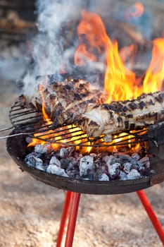 Some pieces of fat on the barbecue. Traditional home slaughtering in a rural area, Extremadura, Spain
