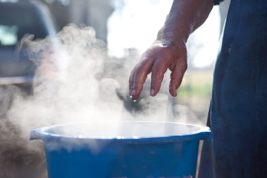 Hot water bucket for cleaning process. Traditional home slaughtering Extremadura, Spain