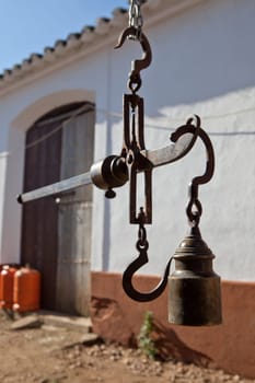 Hanging antique roman steelyard on a farm house, Badajoz, Spain