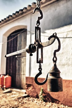 Hanging antique roman steelyard on a farm house, Badajoz, Spain