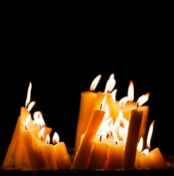 .Lighted church candles in dark