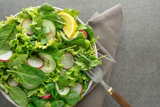 Healthy Green salad with fresh vegetables on grey table background