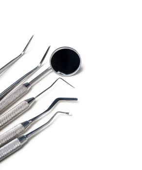 Dental instruments closeup isolated over white