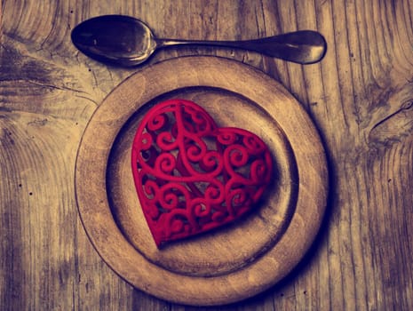 Valentine heart in vintage wooden plate. Retro style