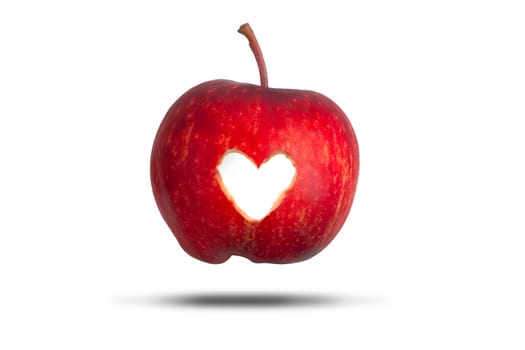 Love heart cut through a red apple isolated on a white background. Love fresh fruit concept