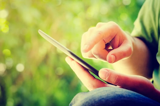 Man holding tablet in the park