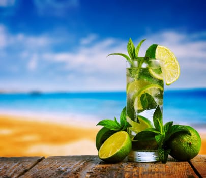 Mojito cocktail and beach in the background
