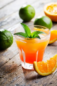 Orange cocktail on rustic wooden table