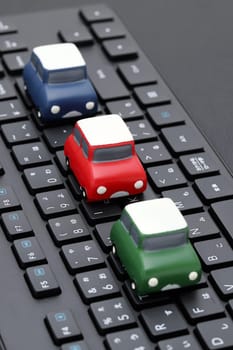 KAGAWA, JAPAN - FEBRUARY 23, 2022 - Small toy car on Alphabetics and Japanese hiragana typing keyboard.