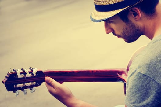 man plays the guitar on the street. retro style.
