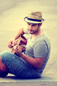 man plays the guitar on the street. retro style.