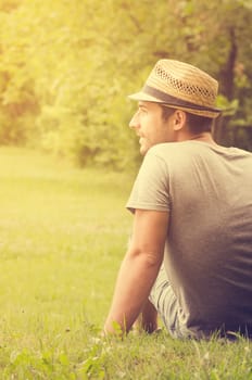 Man sitting on the grass and enjoying the nature