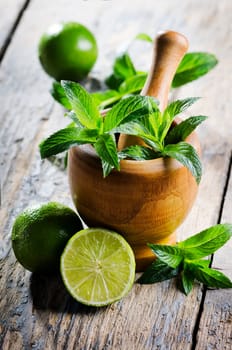 Mojito ingredients on rustic wooden table