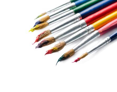 Colorful paint brushes isolated over white