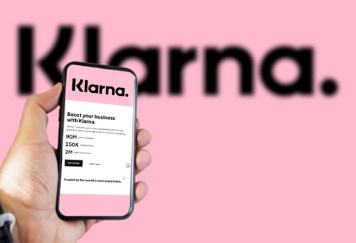 Rome, Italy, February 2022: Hand holding a device with the Klarna mobile app on the screen. Klarna is the largest private fin-tech start-up in Europe, founded by the bank of the same name. Illustrative editorial