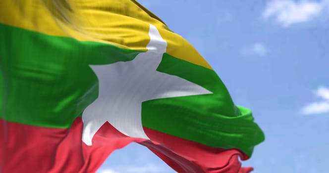 Detail of the national flag of Myanmar waving in the wind on a clear day. Democracy and politics. Patriotism. Selective focus. Myanmar is a country in Southeast Asia
