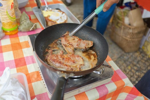 Fried pork in pan .  THAI FOOD