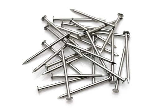 Pile of silver metallic nails isolated on white background