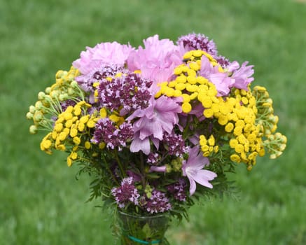 Bouquet of wildflowers ploughed on a wildflower meadow with many different flowers. Wildflower bouquet picked in a wildflower meadow with many different flowers.