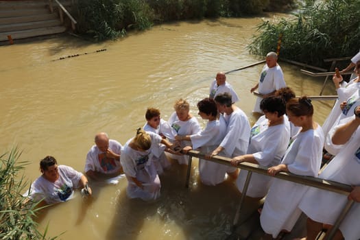 Organised baptism for group of pilgrims in river of Jordan. Jericho. Israel