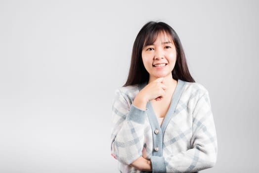 Happy woman hand touch chin handle relaxed thinking about something about the question, Portrait Asian beautiful young female idea think studio shot isolated on white background with copy space