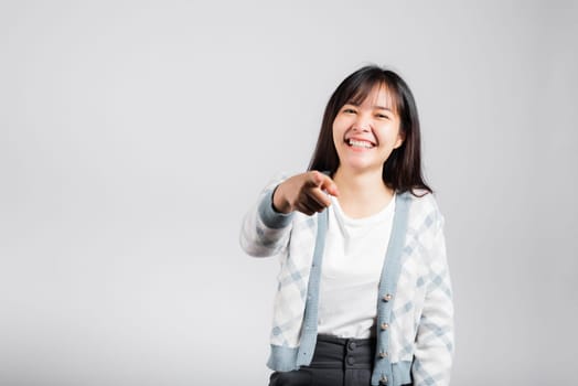 Woman winning and surprised excited screaming laughing pointing finger to camera studio shot isolated white background, Happy Asian portrait beautiful young female lifestyle cheerful laugh funny