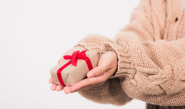 Valentine Day. Female beauty hands holding small gift package box present wrapped paper with ribbon isolated on white background, Christmas, New year, Birthday holiday background concept