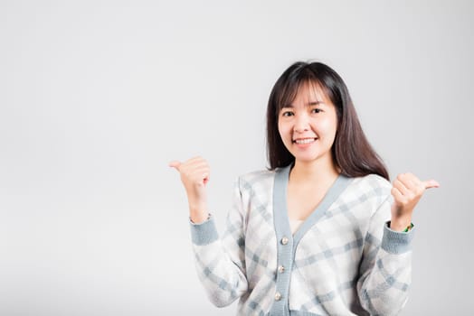 Happy woman smile showing finger thumbs up, Portrait Asian beautiful young female successful like finger gesture, OK sign to agree studio shot isolated on white background with copy space