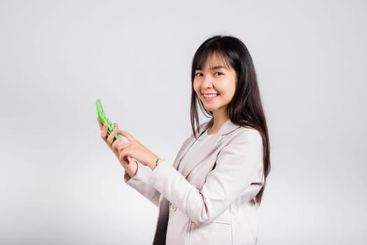 Tax day concept. Woman confident smiling holding electronic calculator, Portrait excited happy Asian young female studio shot isolated on white background, Business Account and finance counting income