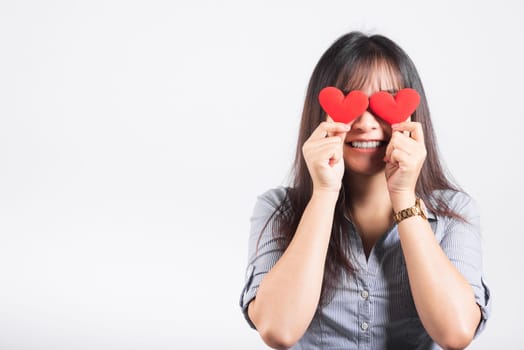 Woman standing her smile confidence cheerful cheery girl holding in hands two red heart symbol cards closing eyes isolated white background, Asian happy portrait beautiful young female valentine