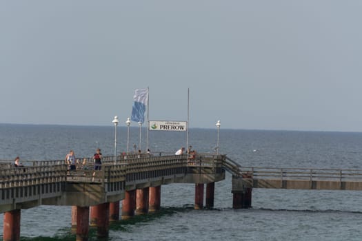 OSTSEEBAD PREROW,  GERMANY - JULY 31, 2018: ..Fishermen and tourists on the wooden pier of the Prerow seaside resort.