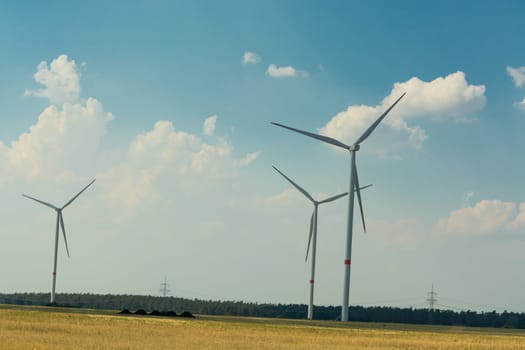 Sustainable green energy. Electric windmill generators in the sunrise