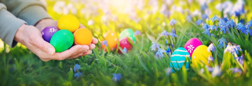 Human hands holding colourful vivid easter eggs. Concept of the Easter celebration.