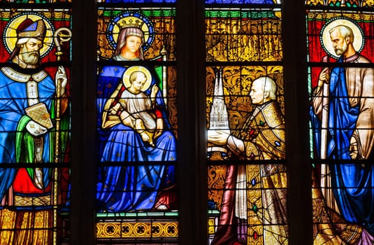 Quimper, Brittany, France - August 11 2017 : Stained glass in the Cathedral of Saint Corentin. Bishop his grace Graveran offering cathedral to Our Lady and St Corentin.