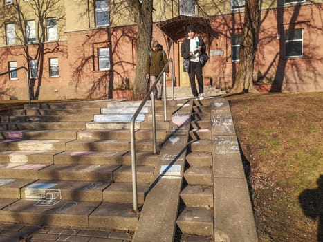 Vilnius, Lithuania. - 28.02.2022: Inscriptions in Lithuanian and Russian languages Freedom to Ukraine and children's drawings in chalk on the steps of the Vilnius Humanitarian School in solidarity with the people of Ukraine against the war and Russian aggression.