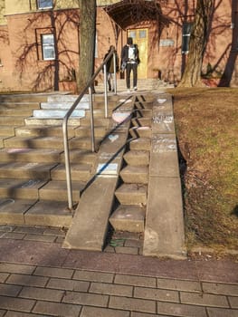 Vilnius, Lithuania. 28.02.2022. Inscriptions in Lithuanian and Russian languages Freedom to Ukraine and children's drawings in chalk on the steps of the Vilnius Humanitarian School in solidarity with the people of Ukraine against the war and Russian aggression.