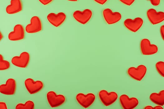 Valentine day green paper background with red hearts background. Valentines day or love concept, copy space